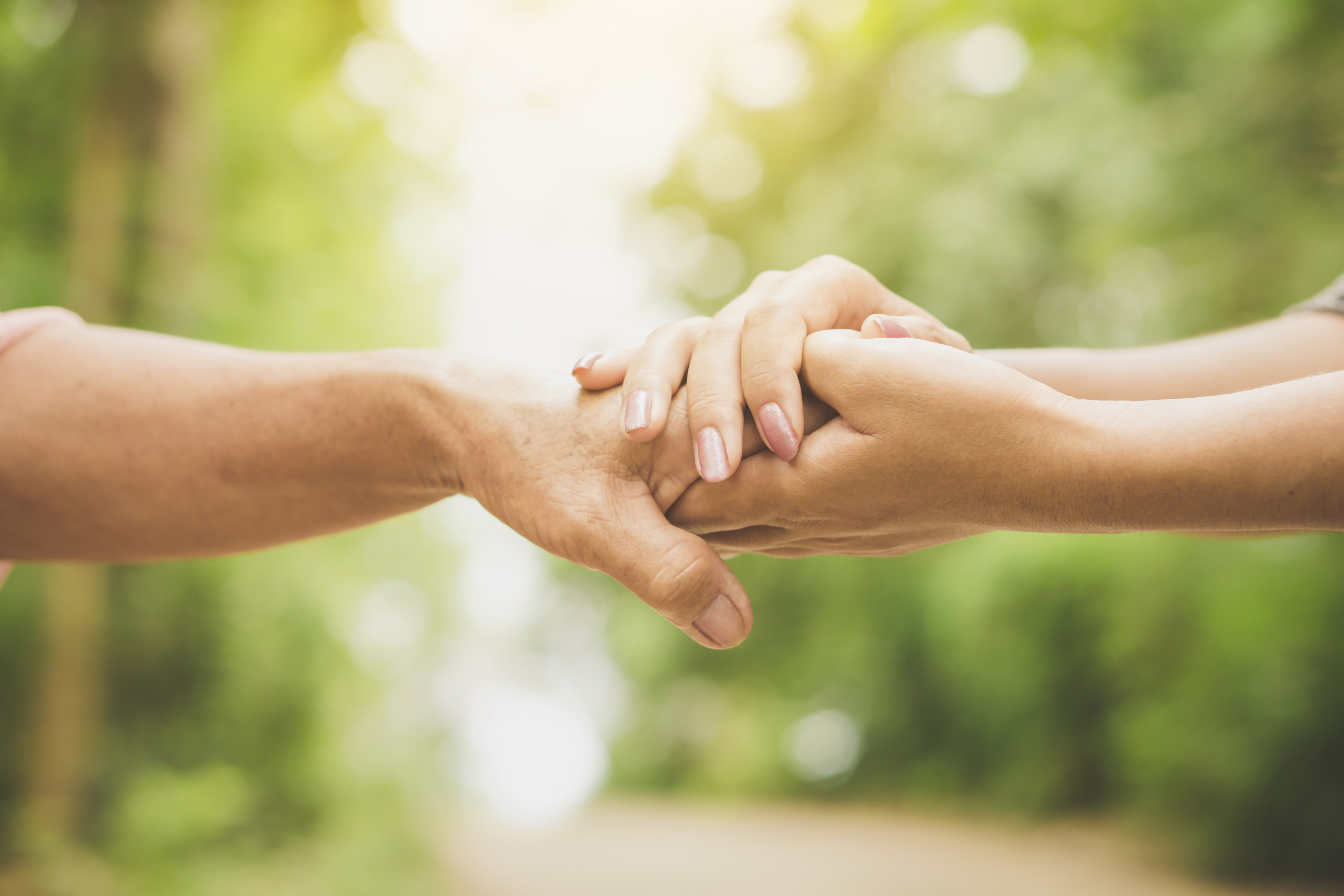 Two hands holding one another
